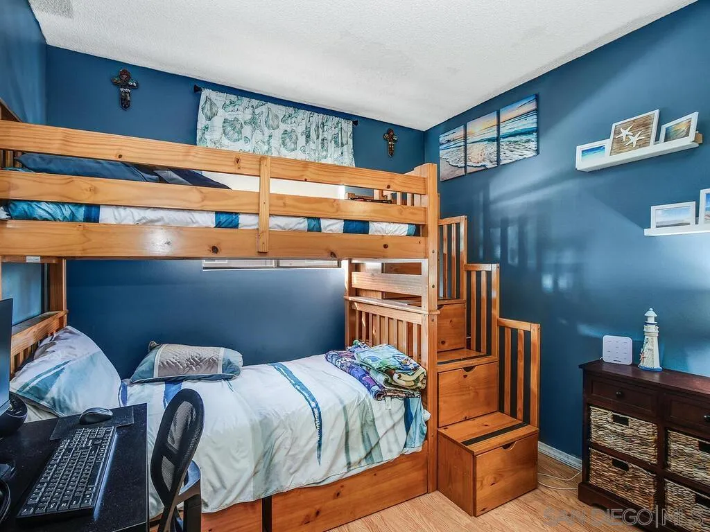 8022 Winter Gardens Boulevard, Unit E El Cajon, CA 92021 - Photo 21 of 30 a bedroom with a bed and wooden floor