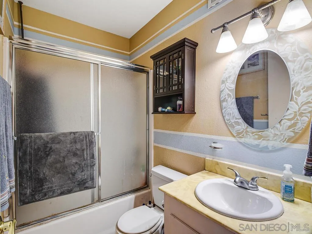 8022 Winter Gardens Boulevard, Unit E El Cajon, CA 92021 - Photo 22 of 30 a bathroom with a sink and a mirror