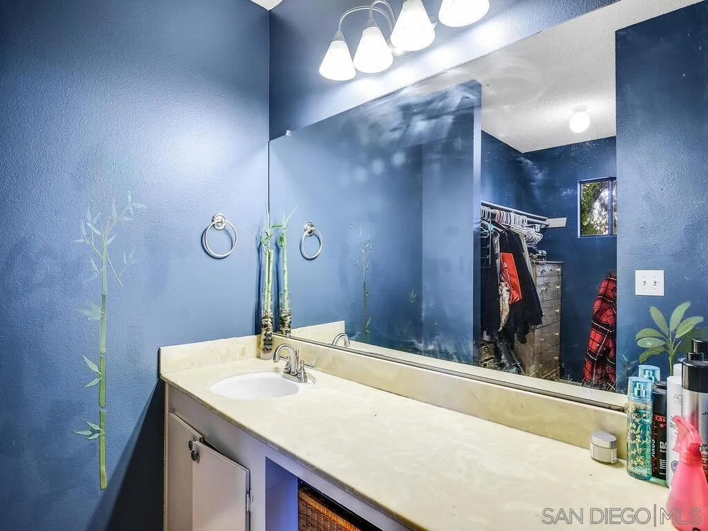 8022 Winter Gardens Boulevard, Unit E El Cajon, CA 92021 - Photo 23 of 30 a bathroom with a sink and a mirror