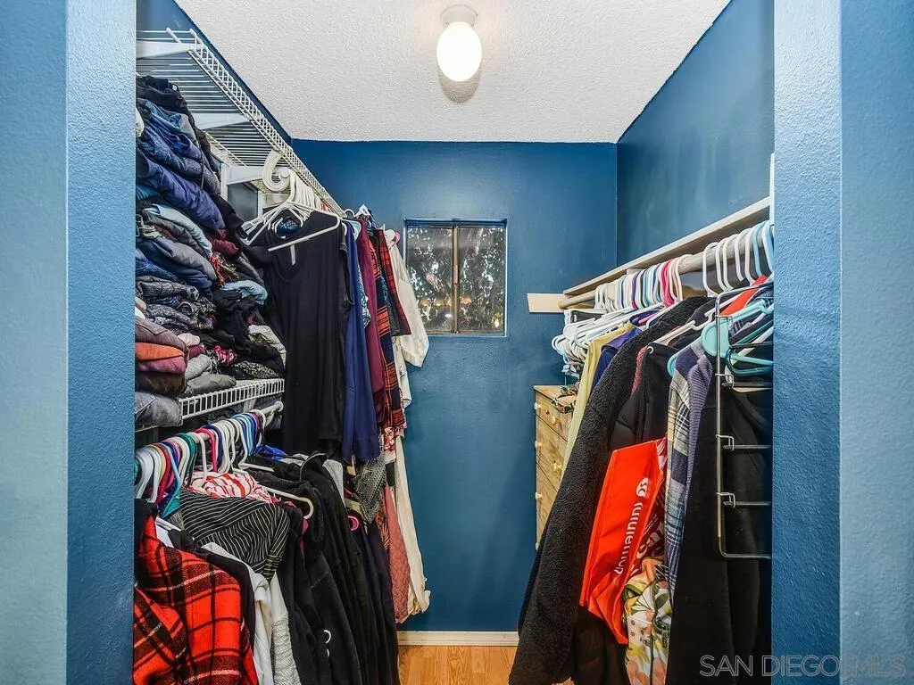 8022 Winter Gardens Boulevard, Unit E El Cajon, CA 92021 - Photo 24 of 30 a view of walk in closet with clothes and shoes