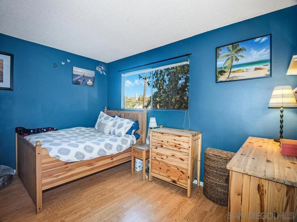 8022 Winter Gardens Boulevard, Unit E El Cajon, CA 92021 - Photo 25 of 30 a bedroom with a bed and a table in it