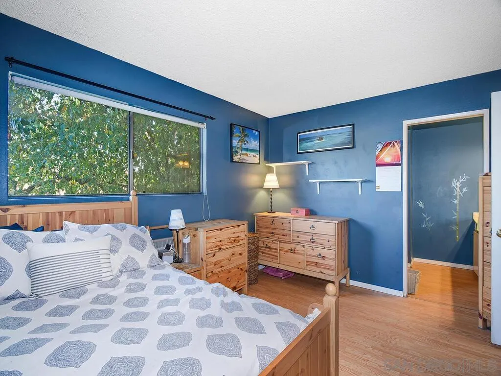 8022 Winter Gardens Boulevard, Unit E El Cajon, CA 92021 - Photo 26 of 30 a bedroom with furniture and wooden floor