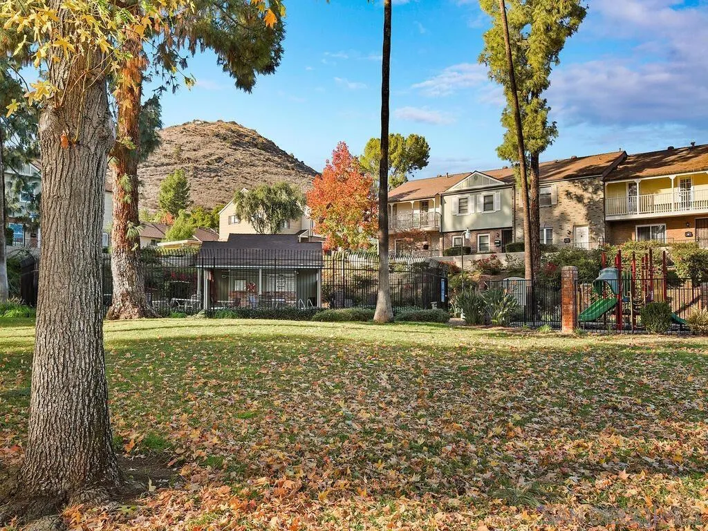 8022 Winter Gardens Boulevard, Unit E El Cajon, CA 92021 - Photo 29 of 30 a front view of a house with a yard