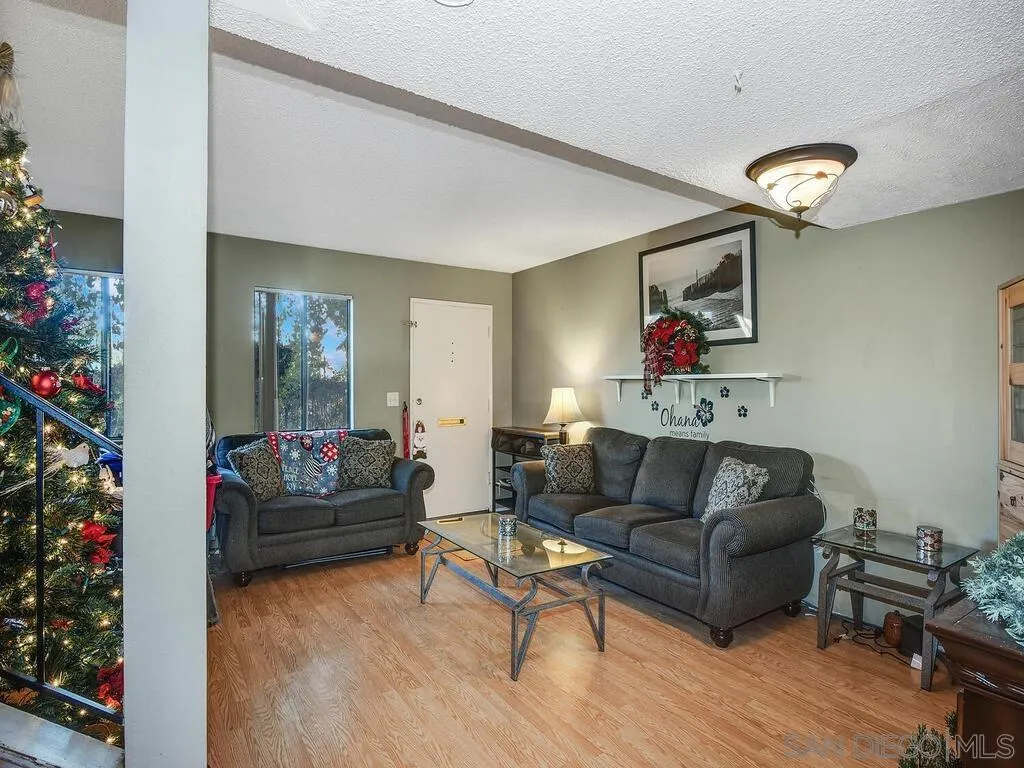 8022 Winter Gardens Boulevard, Unit E El Cajon, CA 92021 - Photo 3 of 30 a living room with furniture and a potted plant