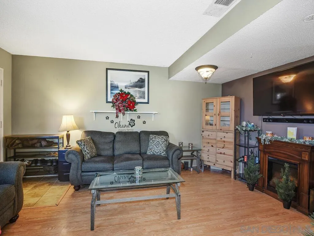 8022 Winter Gardens Boulevard, Unit E El Cajon, CA 92021 - Photo 5 of 30 a living room with furniture and a flat screen tv