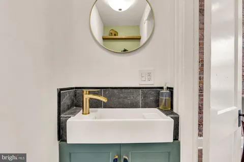 a bathroom with a sink and mirror