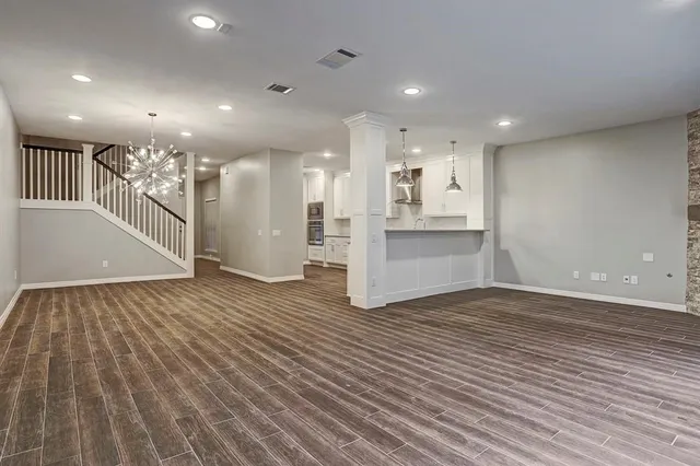 a bedroom with a bed lamp and a window