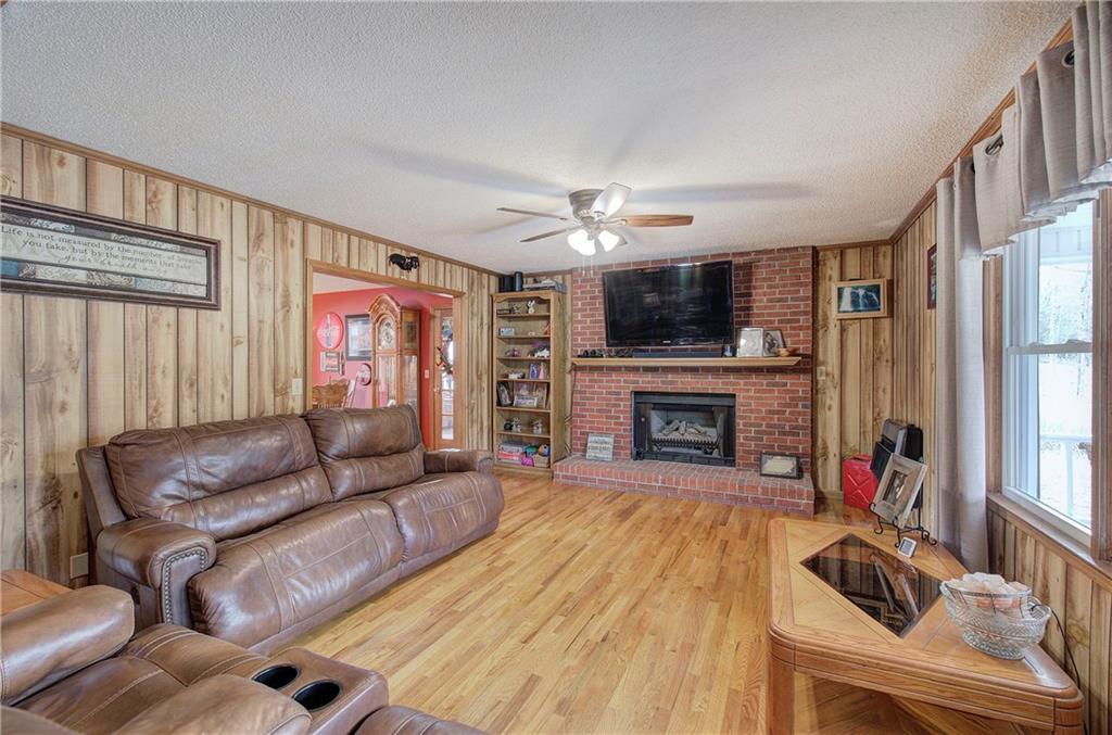 452 Terry White Road Aragon, GA 30104 - Photo 23 of 55 a living room with furniture a flat screen tv and a fireplace