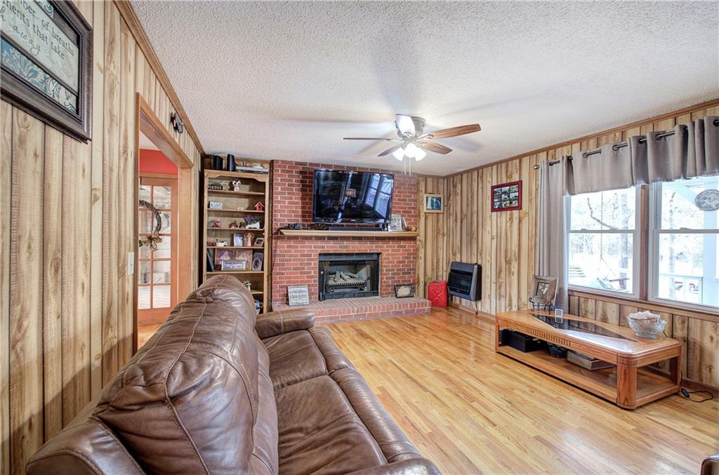 452 Terry White Road Aragon, GA 30104 - Photo 24 of 55 a living room with furniture a fireplace and a large window