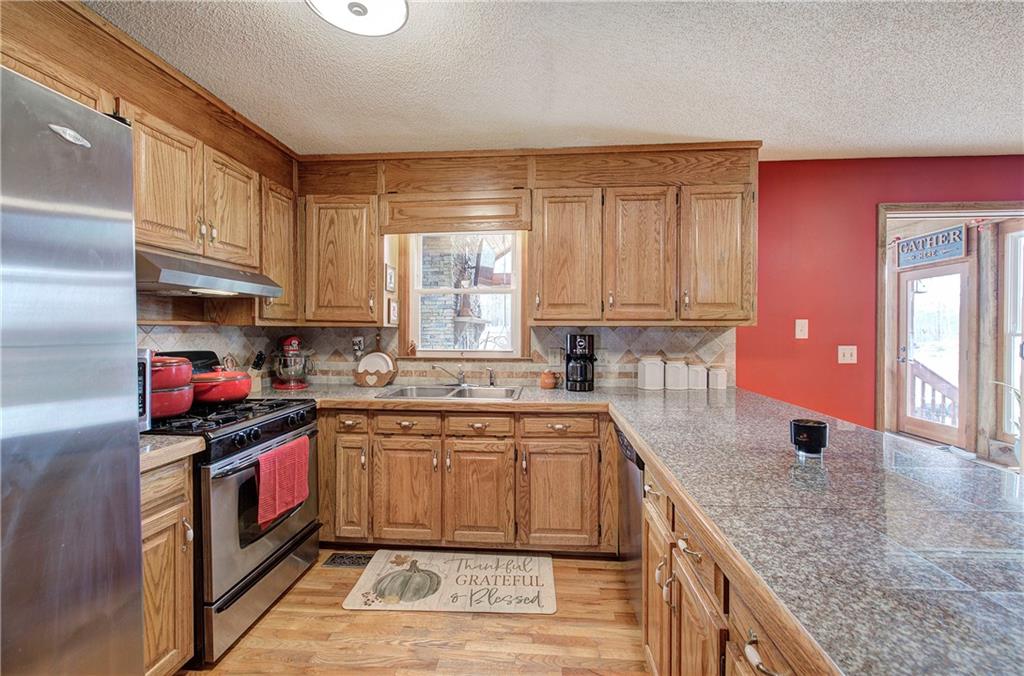 452 Terry White Road Aragon, GA 30104 - Photo 32 of 55 a kitchen with stainless steel appliances granite countertop a sink stove and cabinets