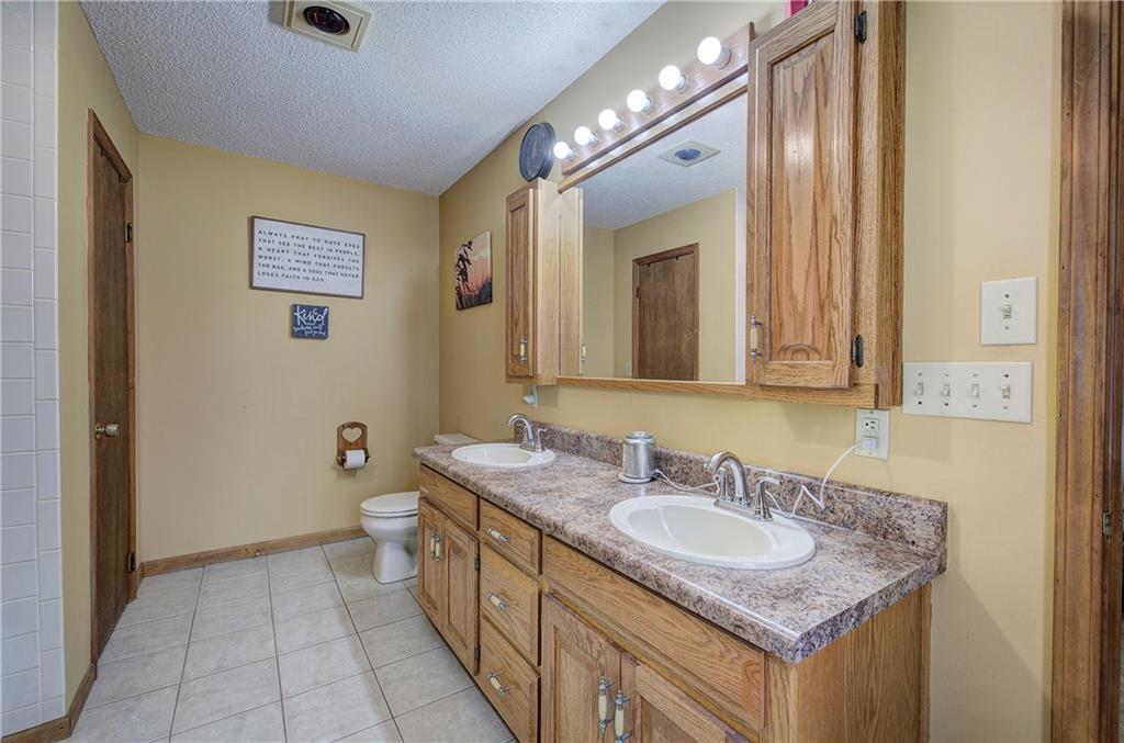 452 Terry White Road Aragon, GA 30104 - Photo 42 of 55 a bathroom with a granite countertop sink and a mirror