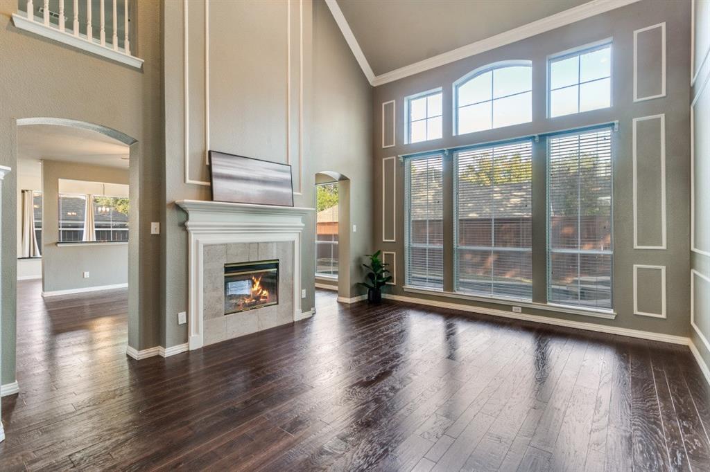 a view of a livingroom with wooden floor a fireplace and window