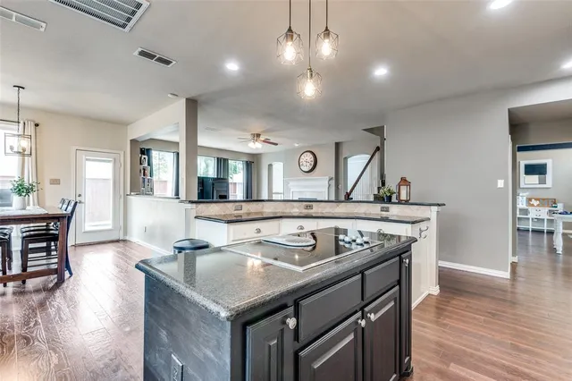 a kitchen that has a sink a stove and a table in it