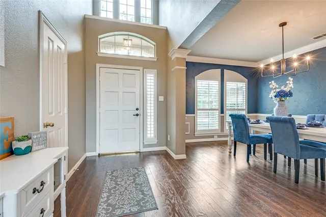 a view of a a dining room with furniture window and wooden floor