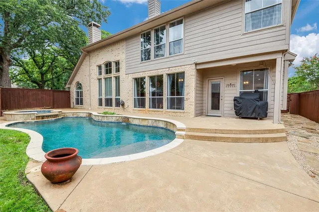 a view of a house with swimming pool and furniture