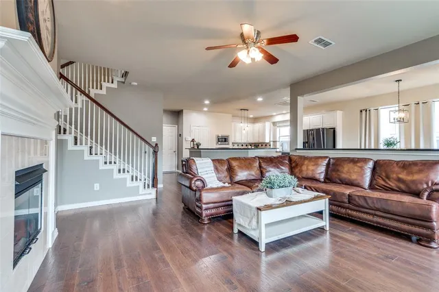 a living room with furniture and wooden floor