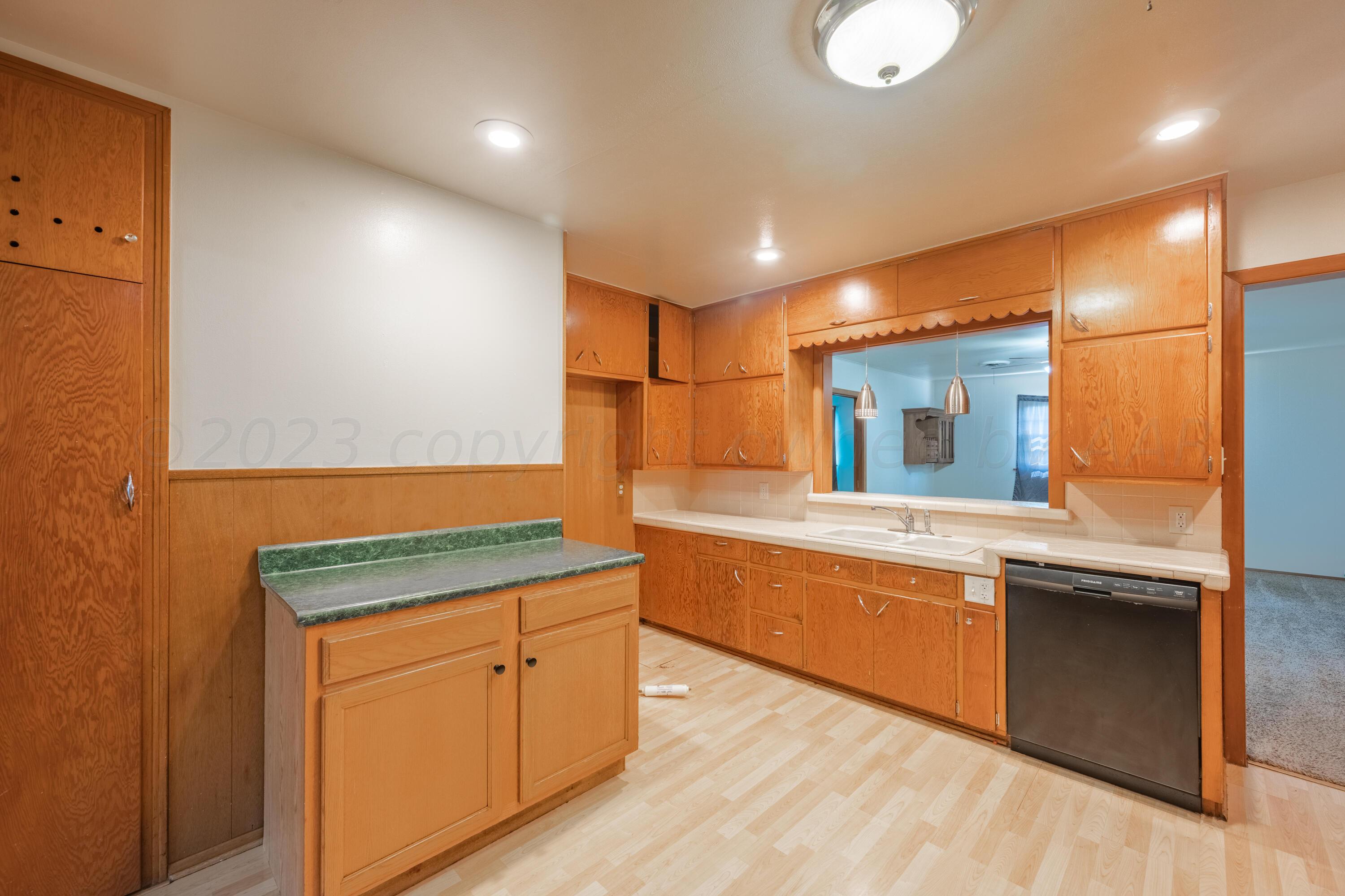 3616 South Travis Street Amarillo, TX 79110 - Photo 13 of 26 a large kitchen with wooden cabinets