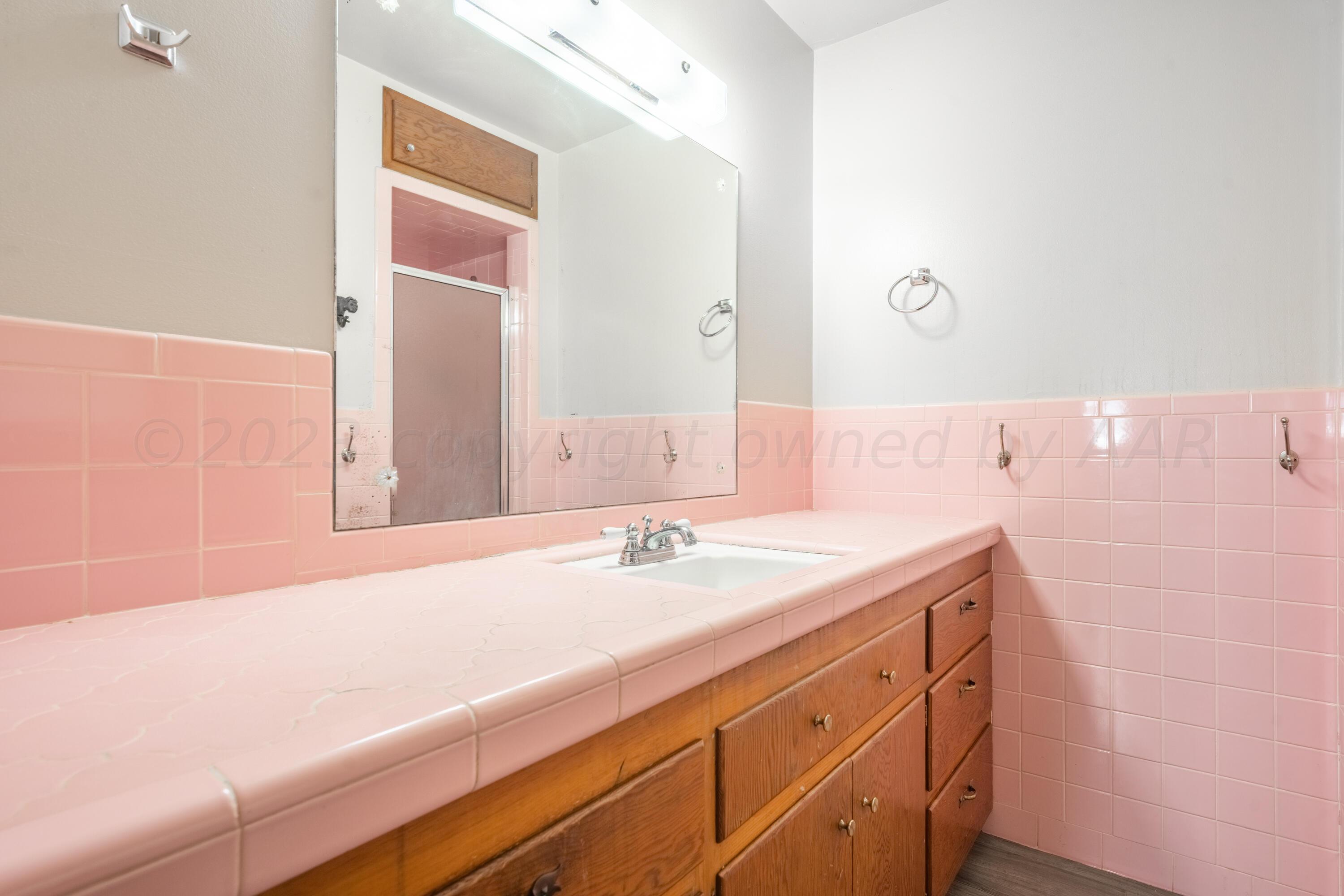 3616 South Travis Street Amarillo, TX 79110 - Photo 17 of 26 a bathroom with a sink and a mirror