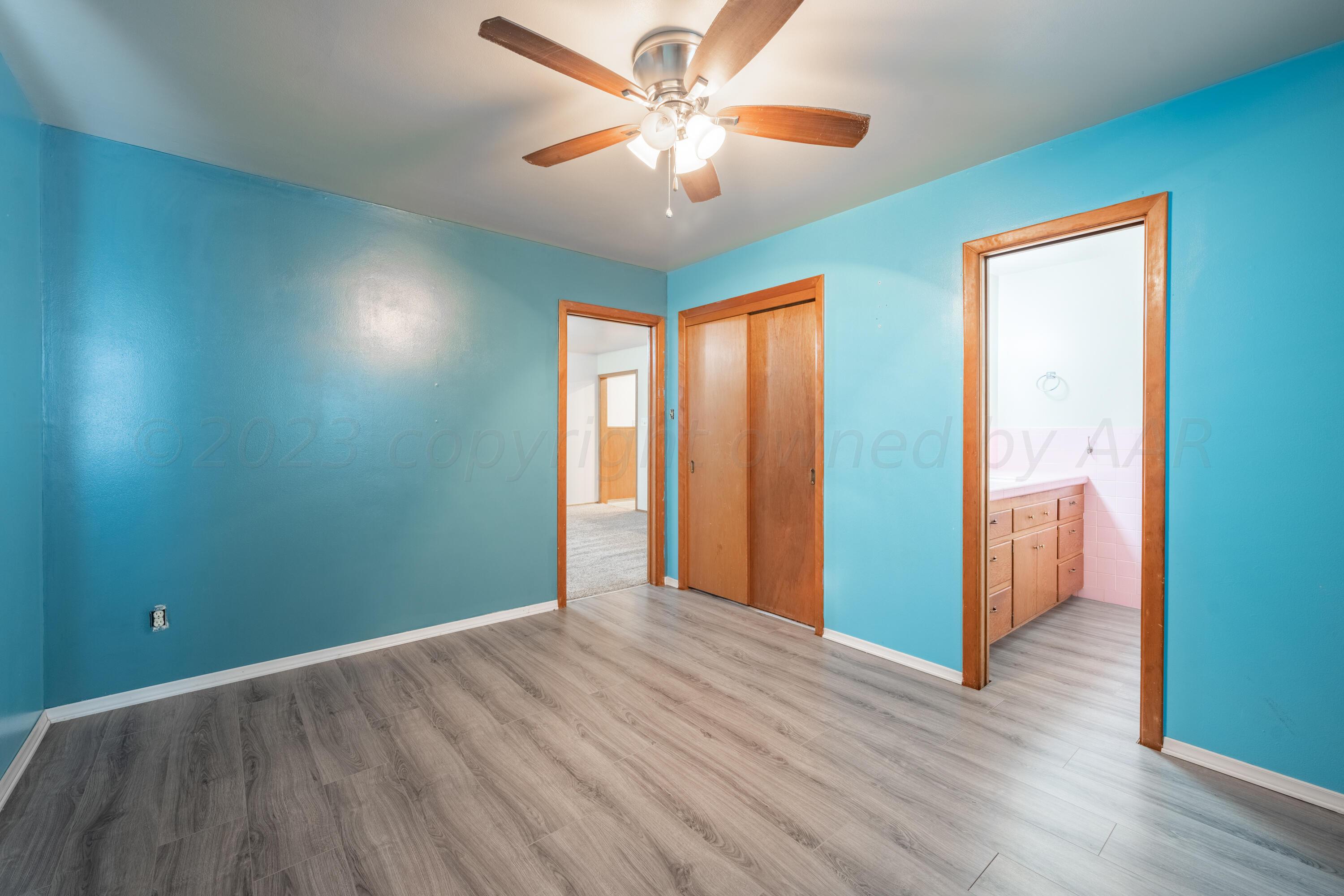 3616 South Travis Street Amarillo, TX 79110 - Photo 20 of 26 wooden floor in an empty room with a window