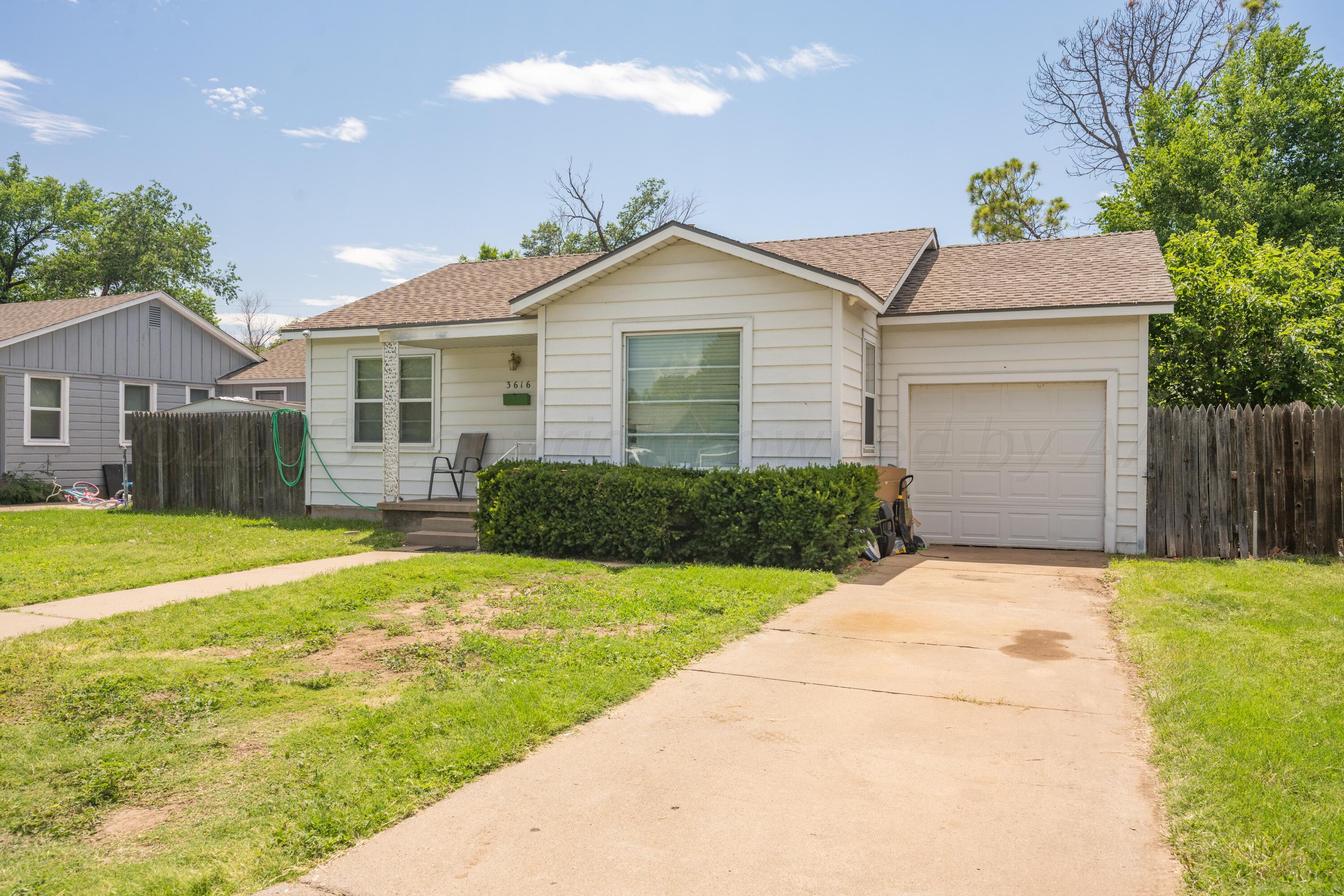 3616 South Travis Street Amarillo, TX 79110 - Photo 2 of 26 a view of a house with a yard and potted plants