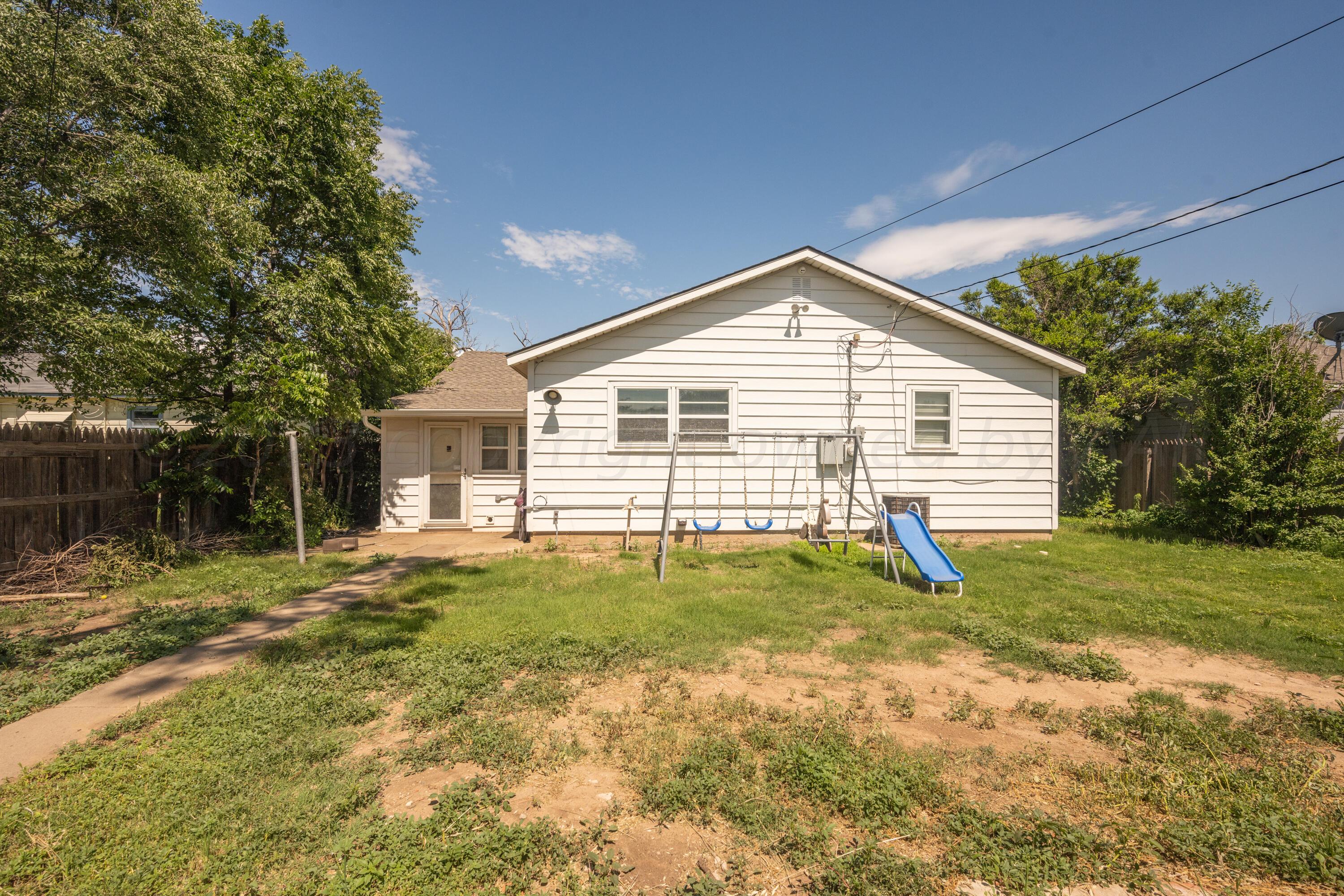 3616 South Travis Street Amarillo, TX 79110 - Photo 21 of 26 a view of a house with a yard and garage