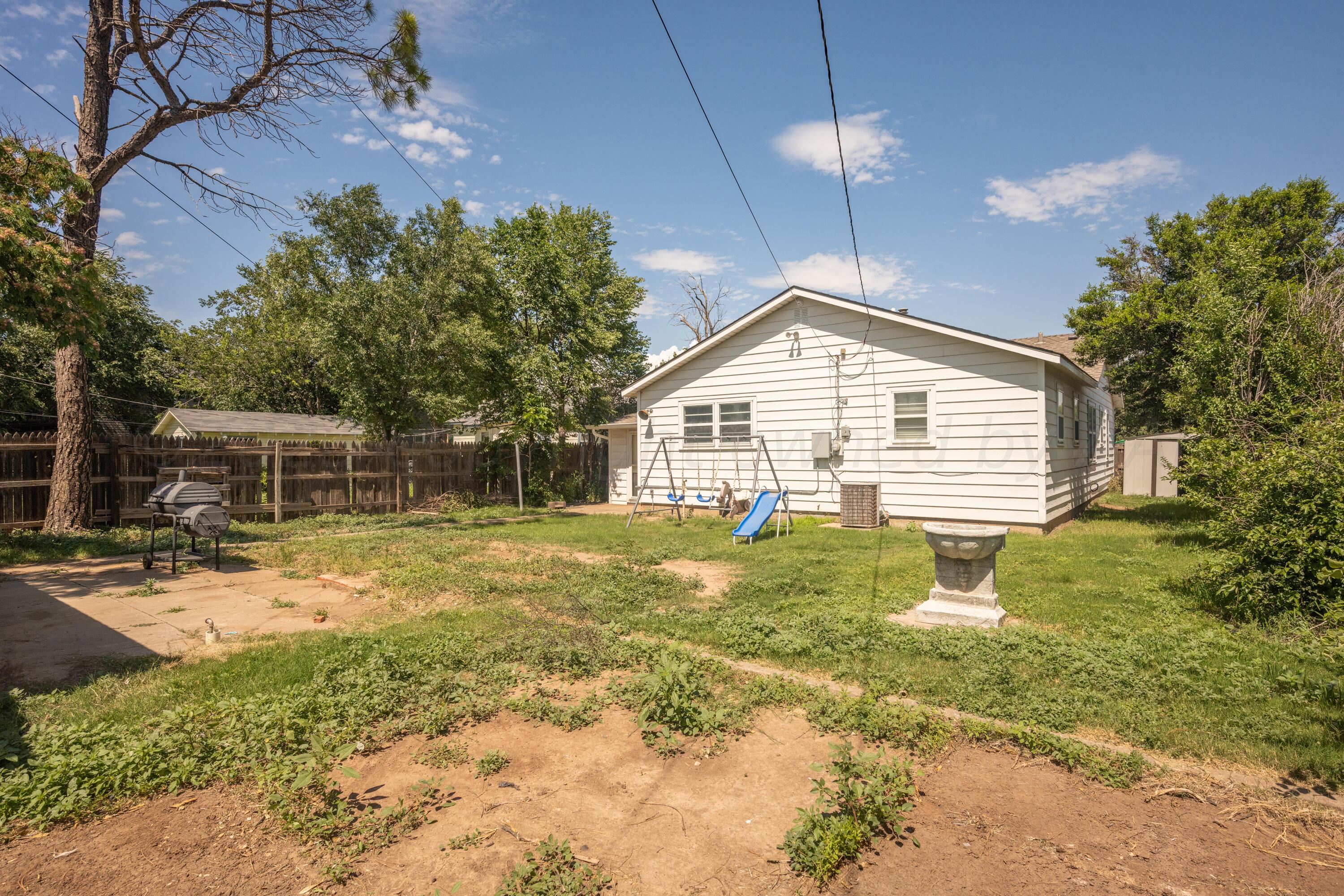 3616 South Travis Street Amarillo, TX 79110 - Photo 23 of 26 a bathroom with a sink and a yard