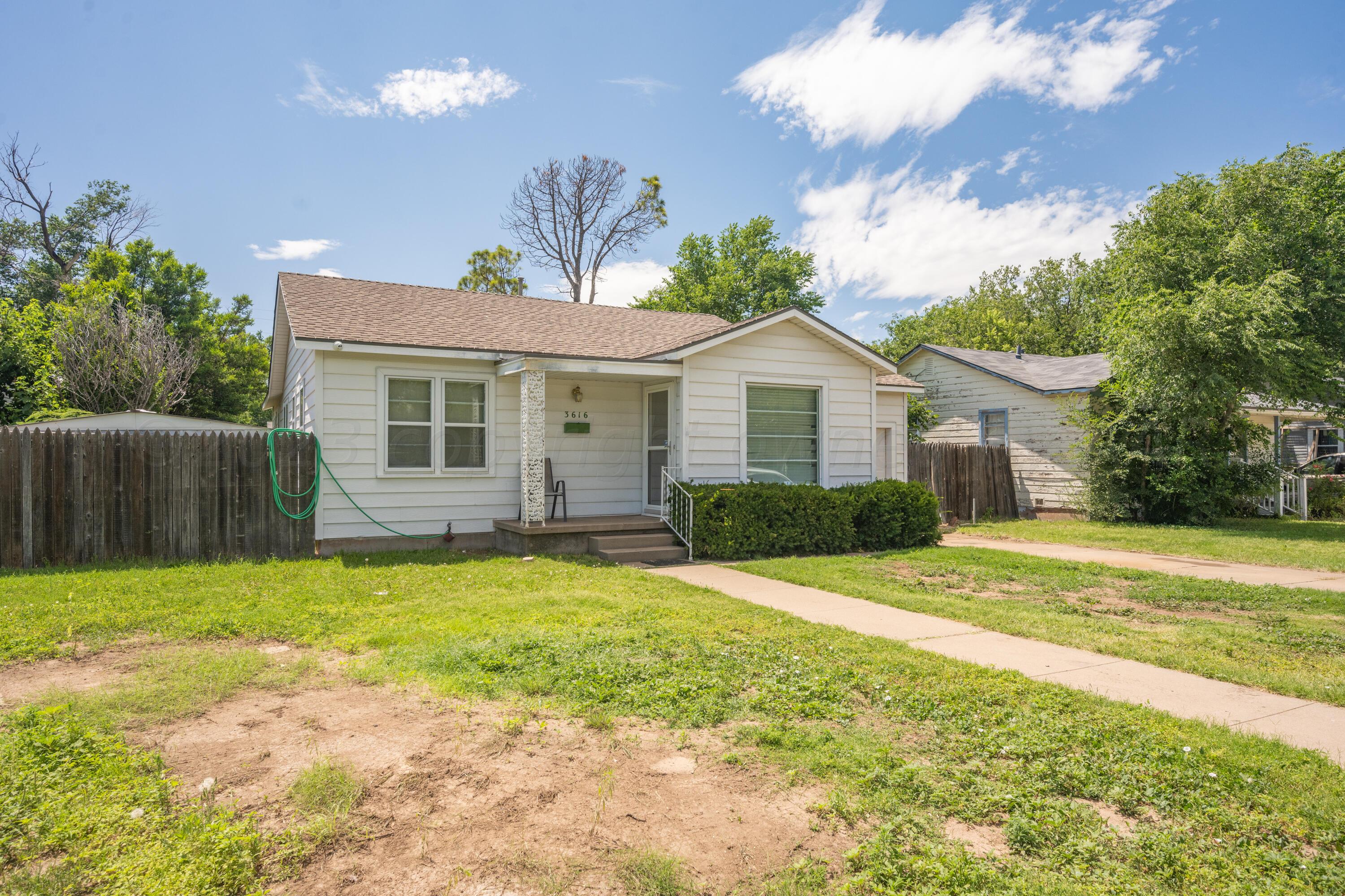 3616 South Travis Street Amarillo, TX 79110 - Photo 25 of 26 a view of a house with a yard and a garden