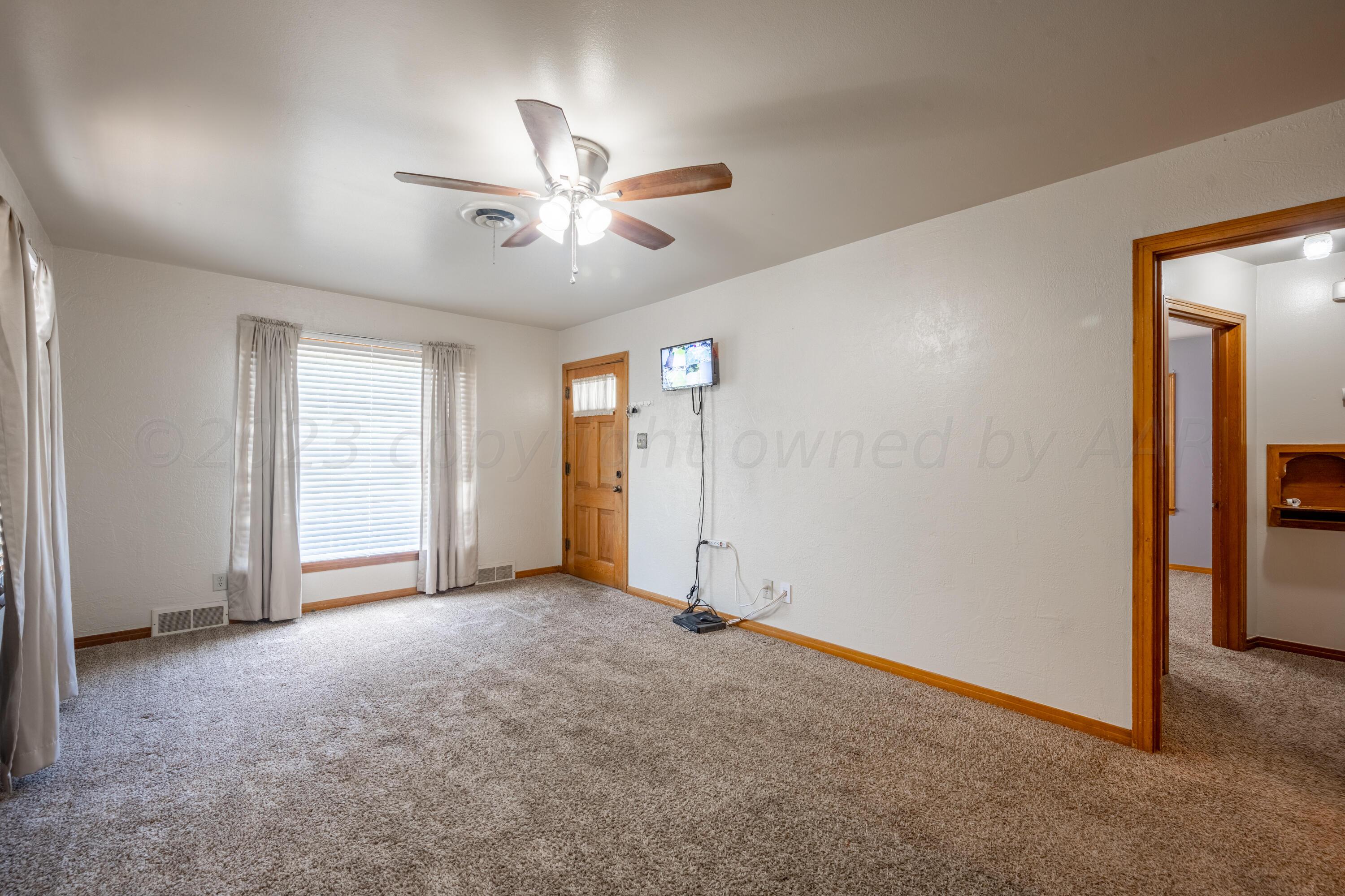 3616 South Travis Street Amarillo, TX 79110 - Photo 5 of 26 a view of empty room with ceiling fan
