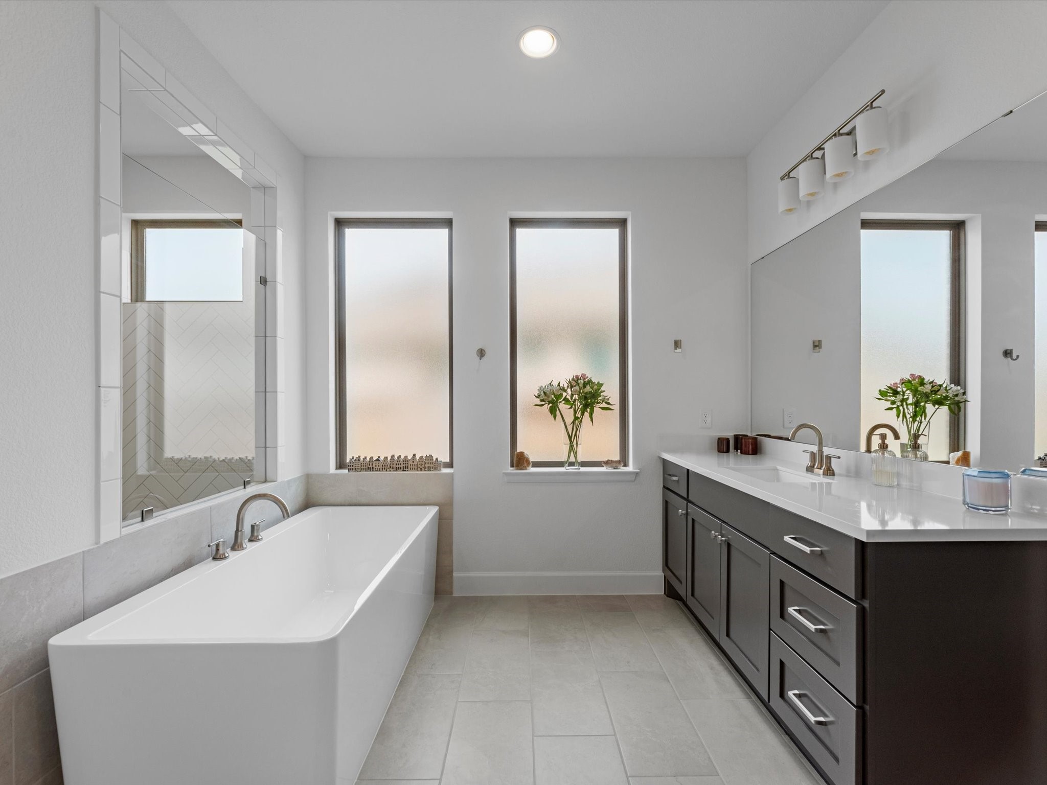 18714 Pistachio Way Manvel, TX 77578 - Photo 21 of 48 Unwind in the freestanding soaking tub, perfectly positioned to enjoy abundant natural light while privacy glass maintains a tranquil, secluded atmosphere.