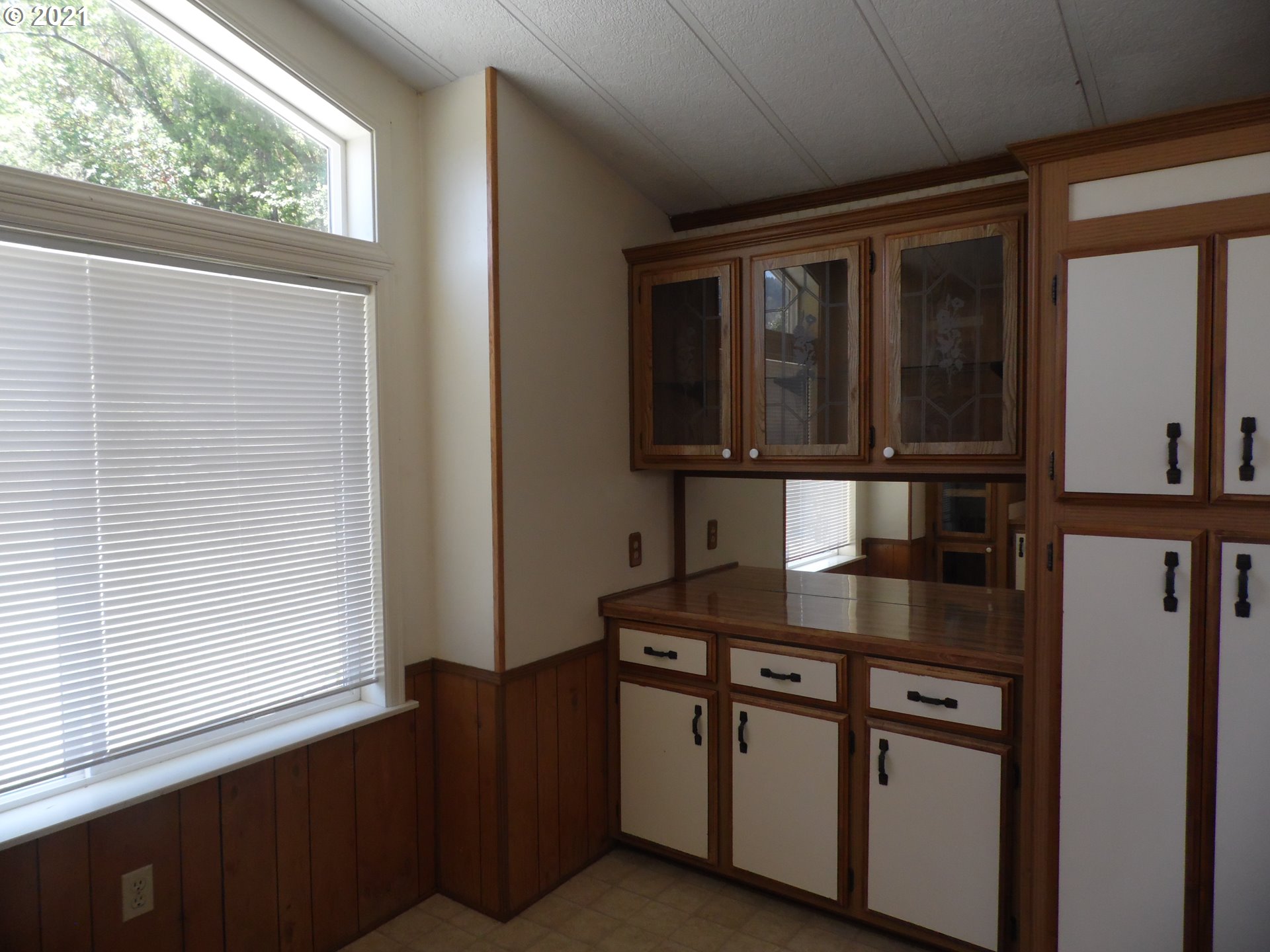1003 Evergreen Ridge Road Riddle, OR 97469 - Photo 4 of 24 a kitchen with stainless steel appliances granite countertop a sink stove and a window