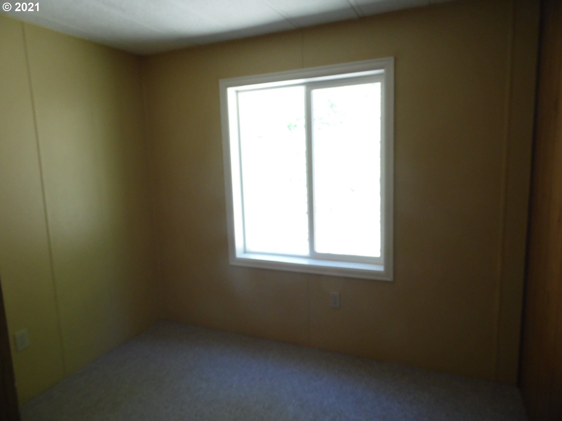 1003 Evergreen Ridge Road Riddle, OR 97469 - Photo 7 of 24 a view of an empty room with a window