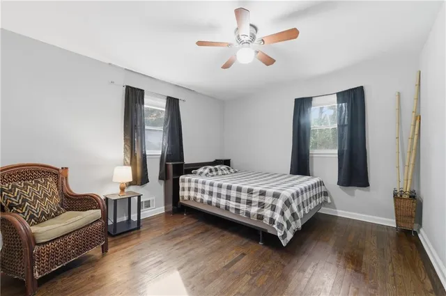 a bedroom with a bed a couch and a chandelier