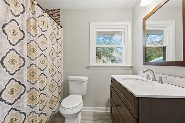 a bathroom with a toilet sink and mirror