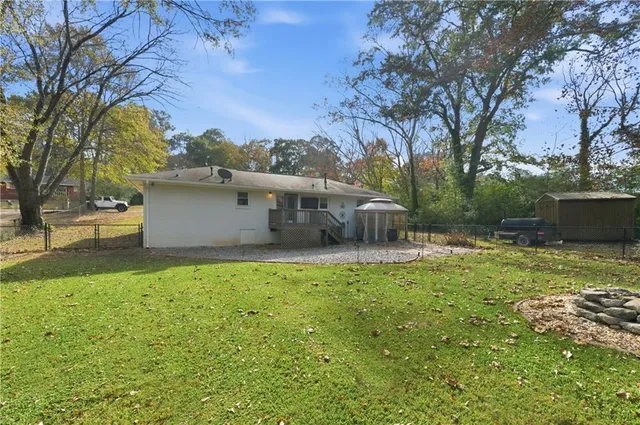 a backyard of a house with table and chairs