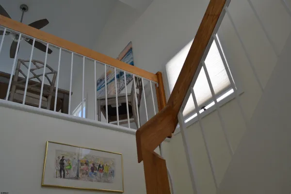 a view of staircase with wooden floor and a window