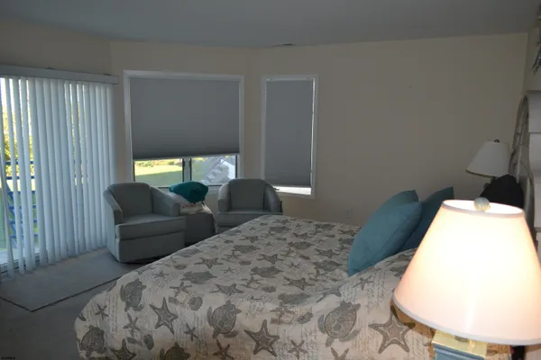 a bedroom with a bed and a couch