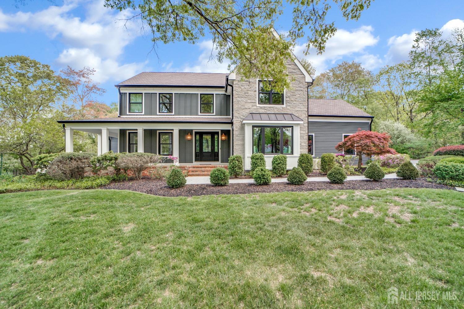 a front view of a house with a yard and potted plants