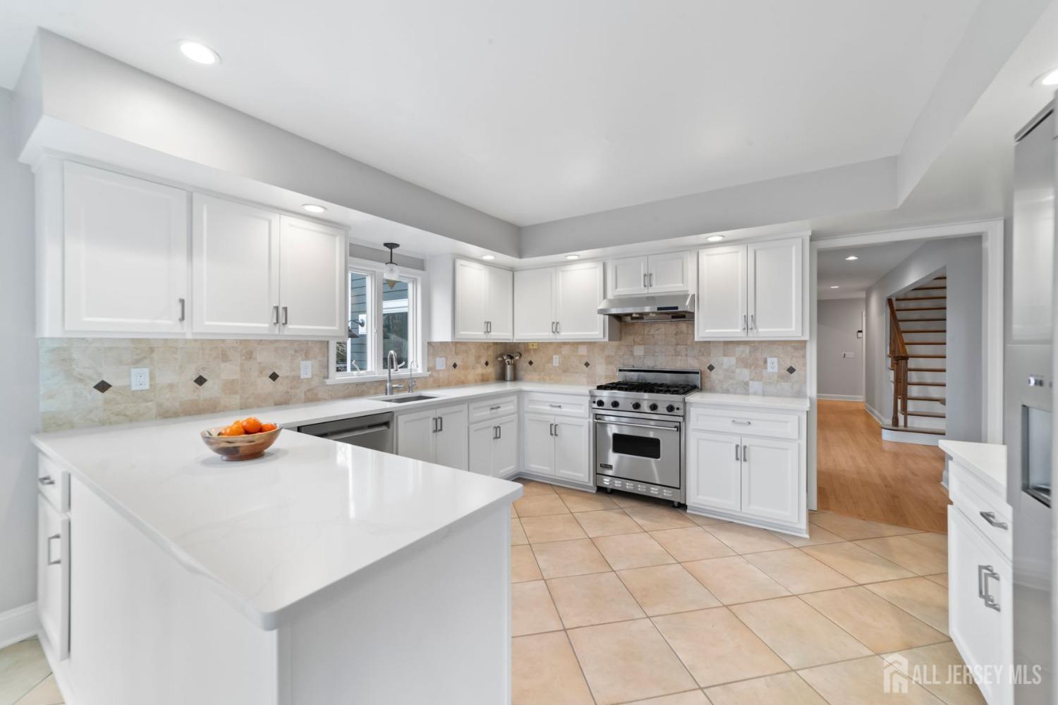 325 Spring Hill Road Skillman, NJ 08558 - Photo 11 of 46 a kitchen with a sink white cabinets and stainless steel appliances