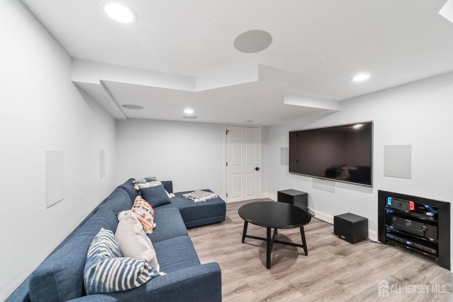 325 Spring Hill Road Skillman, NJ 08558 - Photo 28 of 46 a living room with furniture and a flat screen tv