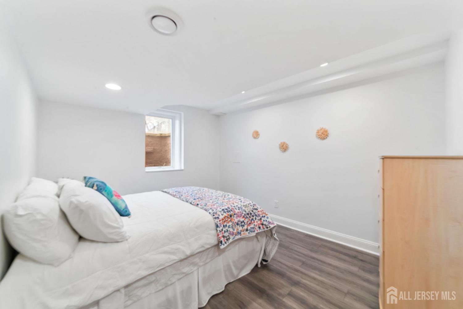 325 Spring Hill Road Skillman, NJ 08558 - Photo 29 of 46 a bedroom with a bed and wooden floor