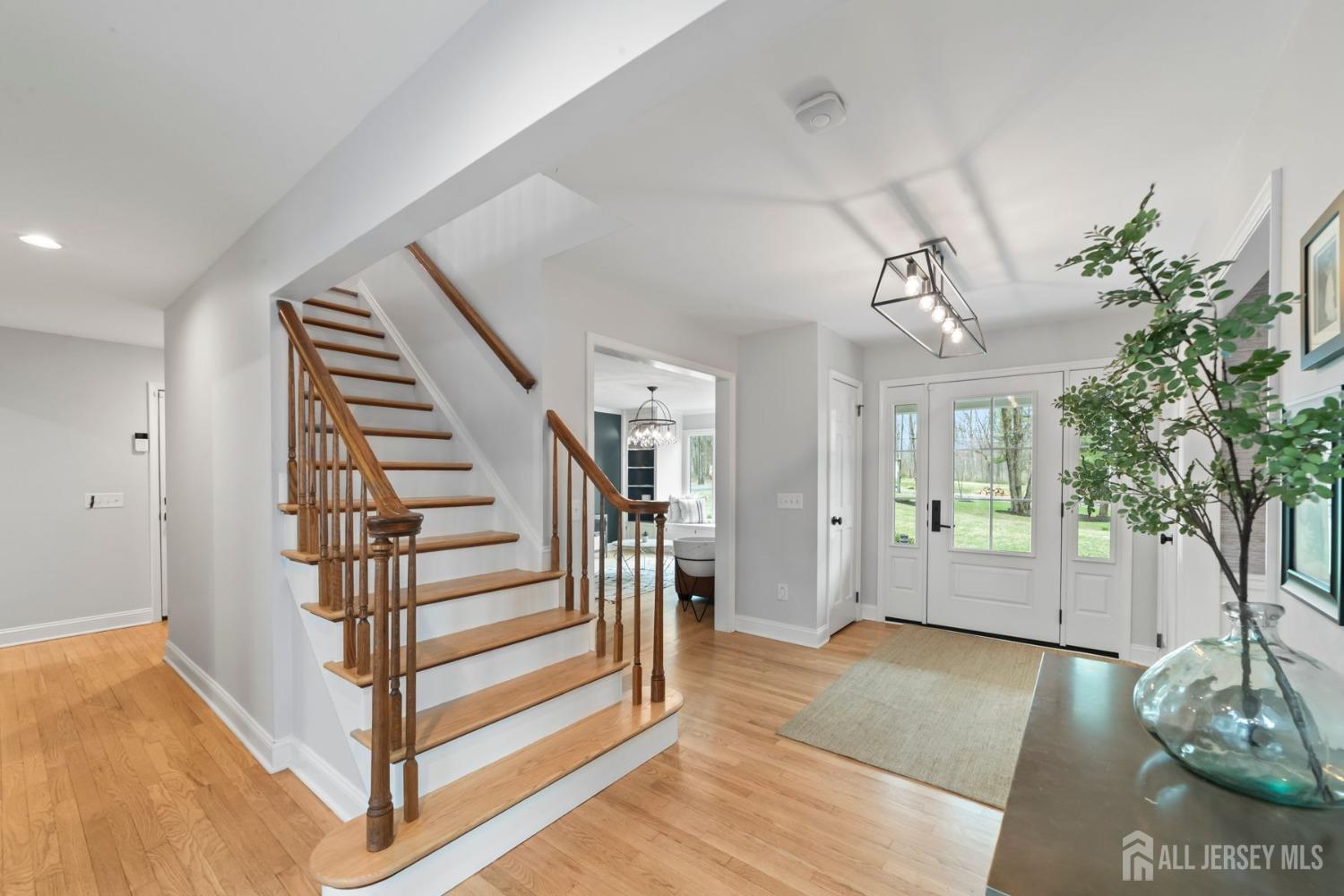 325 Spring Hill Road Skillman, NJ 08558 - Photo 4 of 46 a view of entryway with stairs and wooden floor