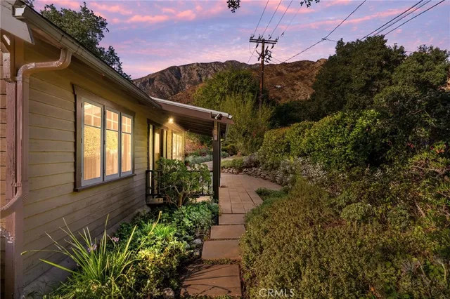 a pathway of a house with a yard