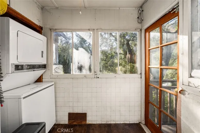 a view of a room with wooden floor and windows