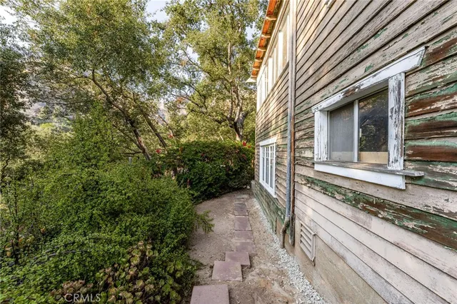 a view of roof with two trees in front of it