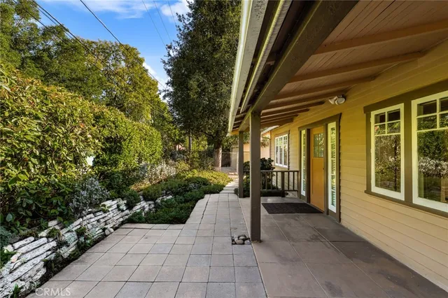 a view of a porch with furniture and a yard