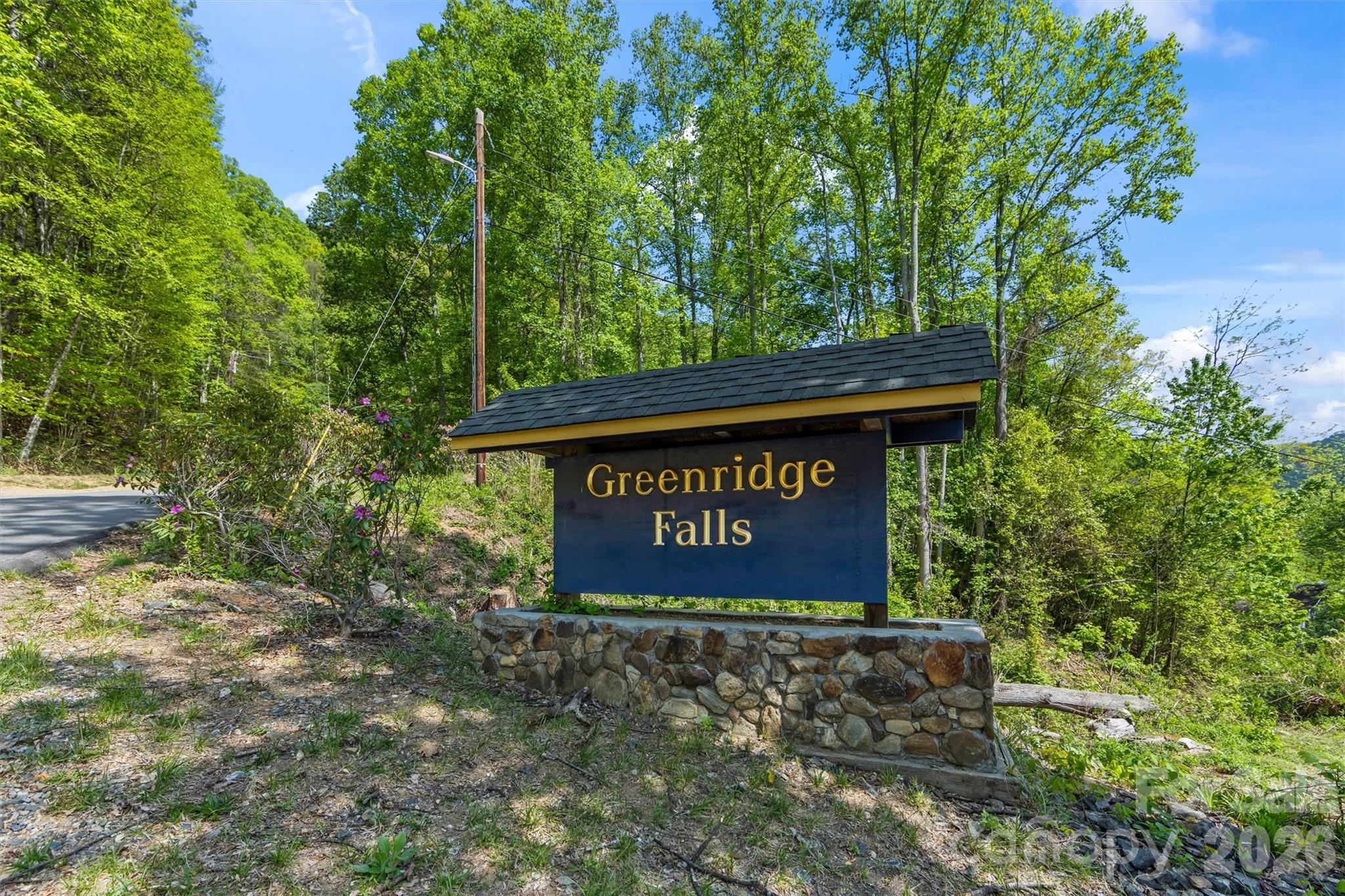 21 Reillys Bluff Road, Unit 1 Barnardsville, NC 28709 - Photo 6 of 15 a sign that is sitting on a brick wall