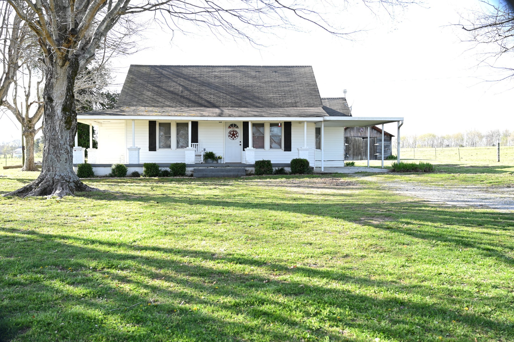 10996 Shelbyville Road Morrison, TN 37357 - Photo 1 of 26 a front view of a house with a garden and trees