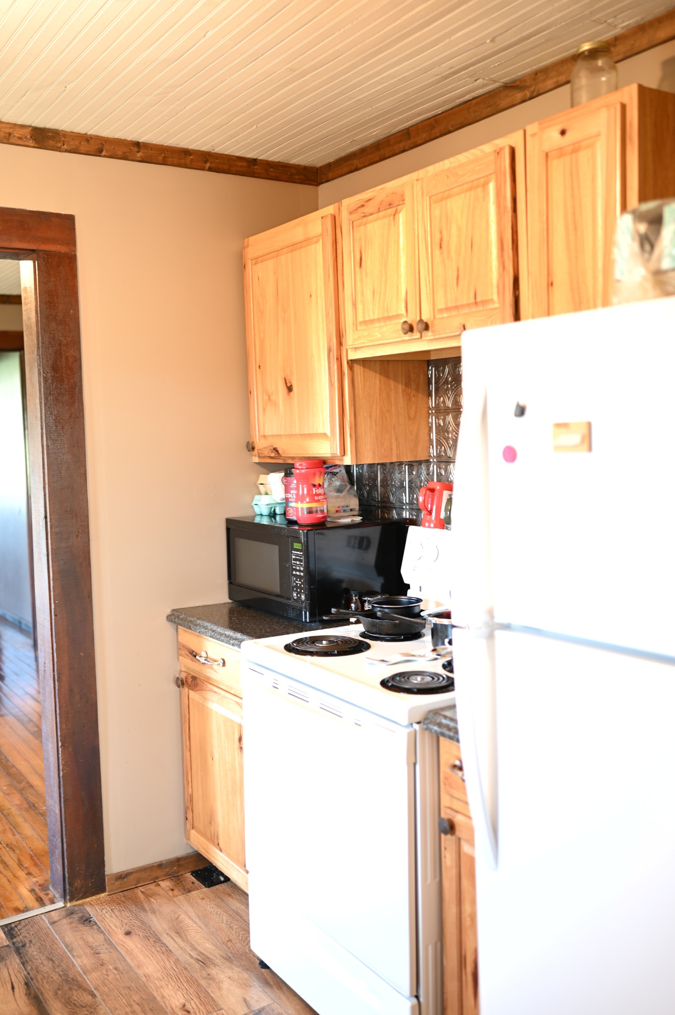 10996 Shelbyville Road Morrison, TN 37357 - Photo 19 of 26 a kitchen with a stove a microwave and refrigerator