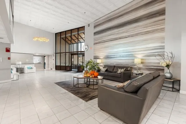 a view of a hallway with livingroom and furniture