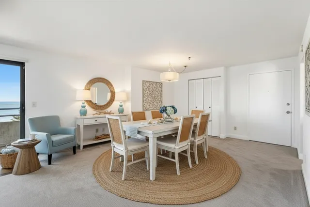 a view of a dining room with furniture and a chandelier